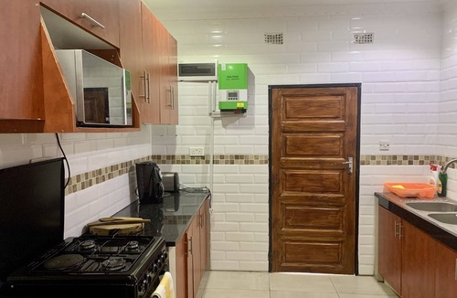 Lusaka Cottage | Cozy, quiet and beautiful two bedroom gated cottage. Full kitchen & pool access.