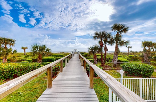 Cape Caneveral Beach Gardens Condo | Pristine condo with shared pool, hot tub, and balcony with partial ocean view