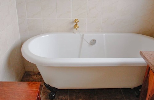 Nyanga Cabin | Rustic stone walls with modern conveniences in an African setting.