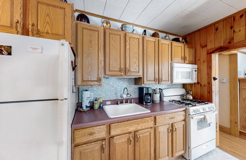 Warrensburg Cottage | Tree-lined dog-friendly cottage with wrap-around deck, grill, & gas fireplace