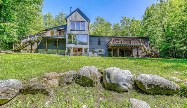 Beautiful, modern home w/ a spacious deck, pool table, & multiple fireplaces