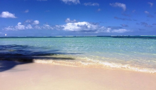 Vaima Beach Retreat- modern air conditioned apartment/condo steps to the Beach!